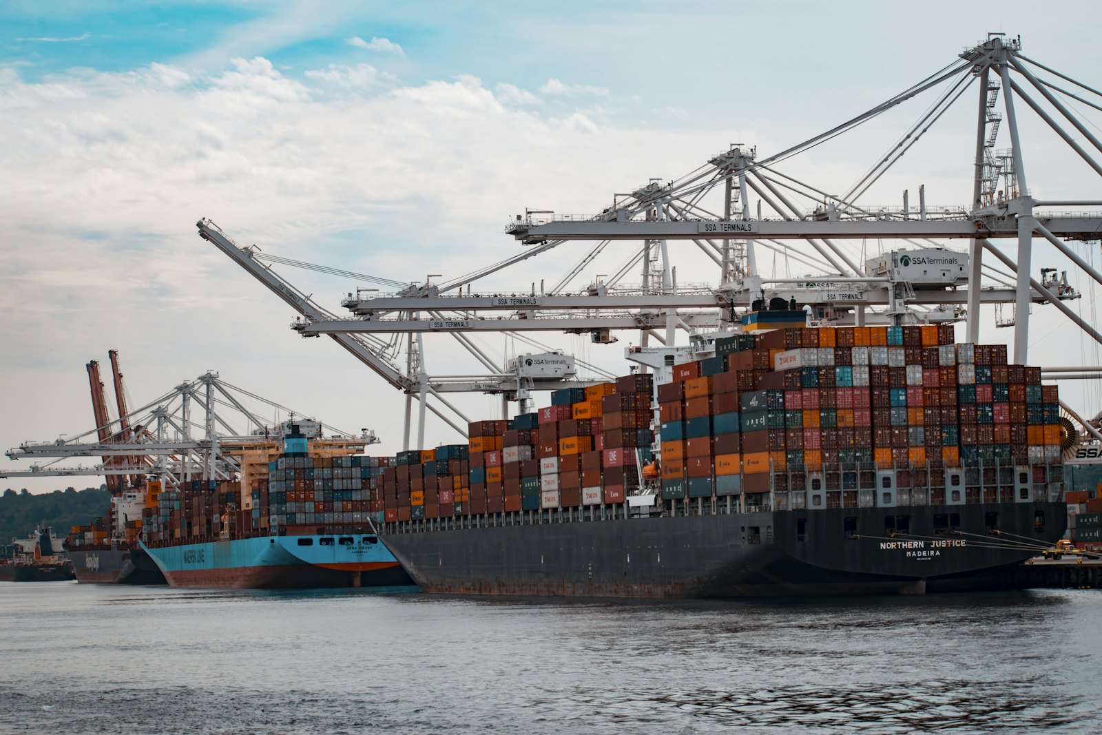 Container ship at port with gantry cranes